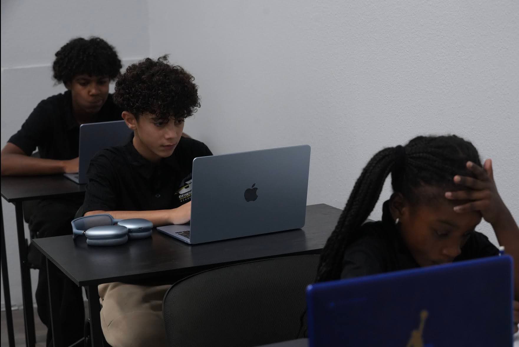 Genesis Hoops Academy athletes working through their school block on laptops in Temecula